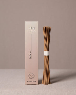 Balance essential oil incense sticks beside their pale pink box