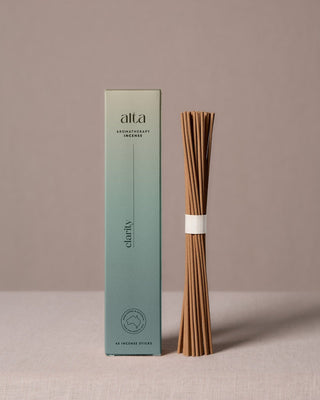 Clarity essential oil incense sticks beside their sage green box