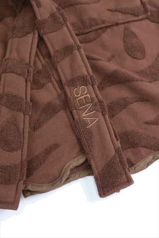 Close up of the embroidered belt and wave texture on the chocolate SENA cotton robe